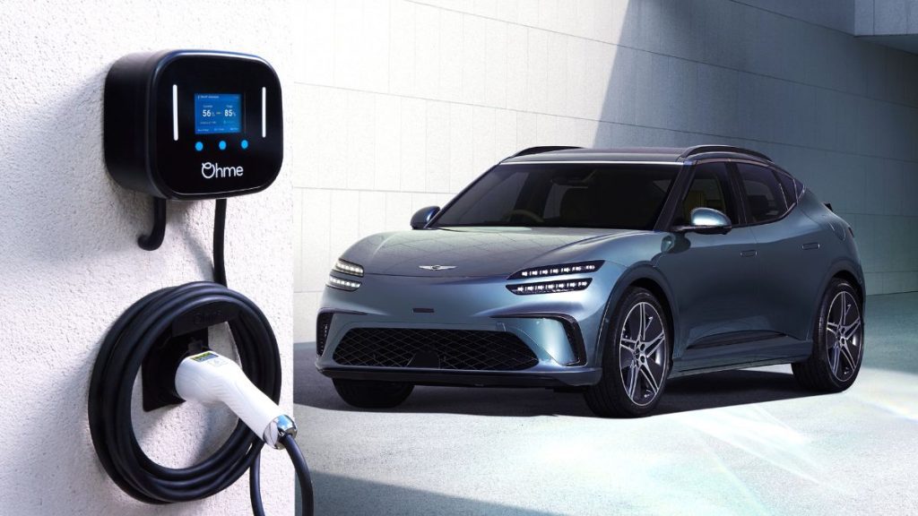 A blue Genesis EV parked up next to an Ohme home charging unit
